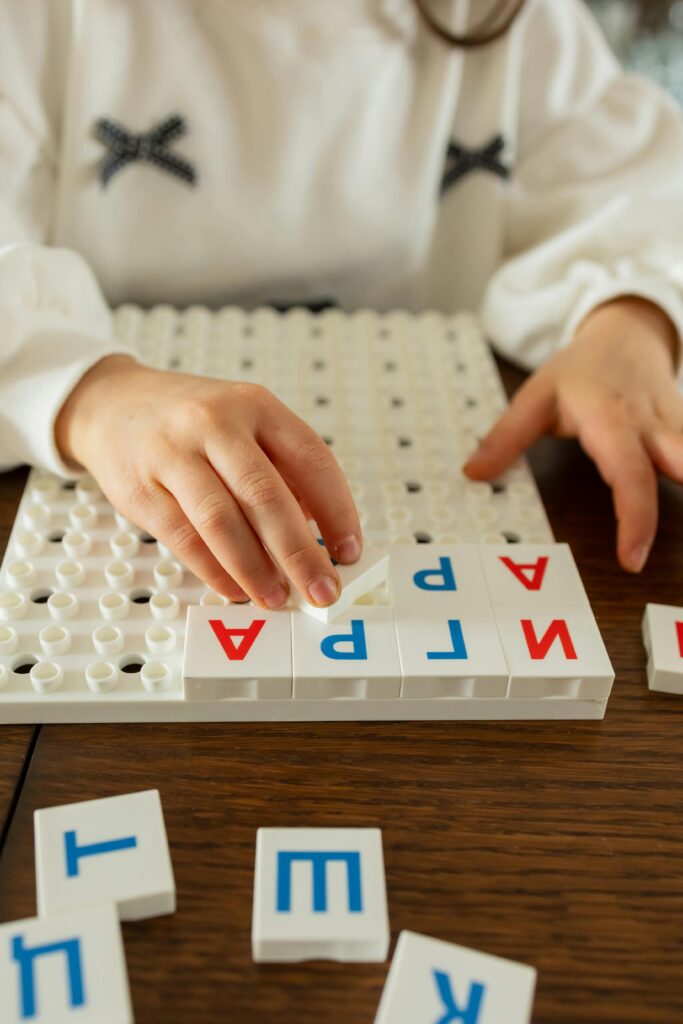 Young child interacting with alphabet blocks for learning.